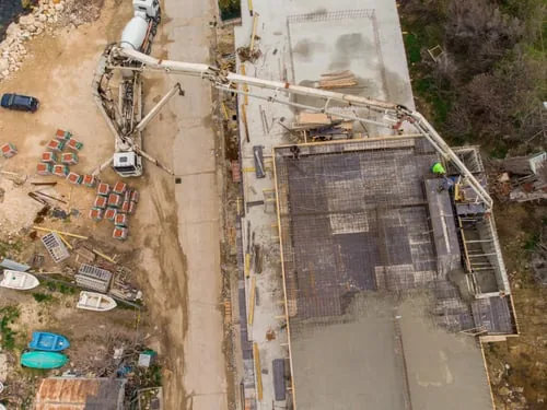 Concrete pump truck placing a rebar-reinforced slab on a construction site in Charlotte, NC